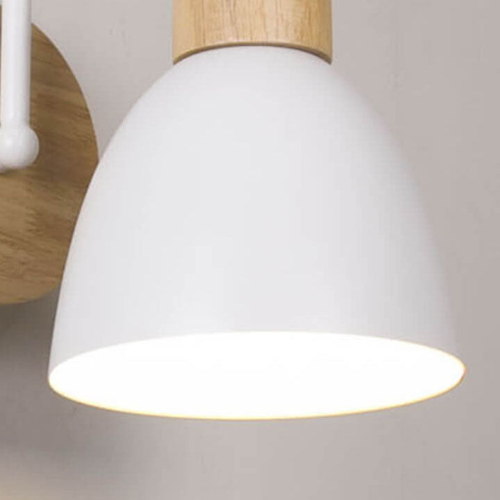 Close-up of a pendant light with white shade and wooden fixture on a neutral background