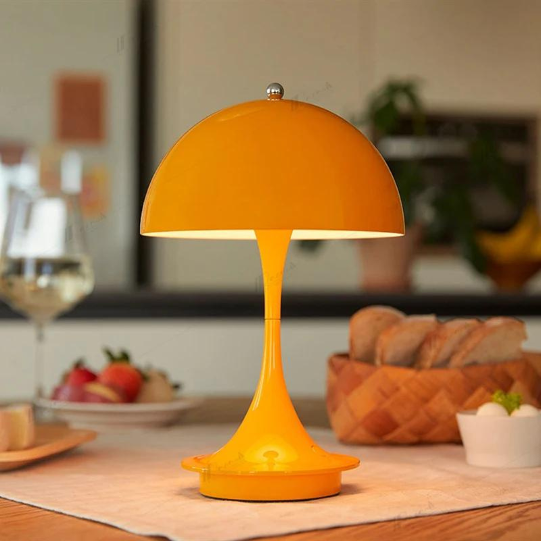 Orange table lamp on a wooden table with a blurred background