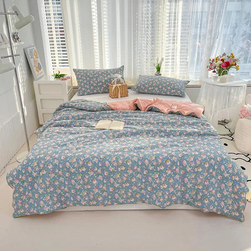 Floral patterned bedding set on a bed in a bright bedroom.