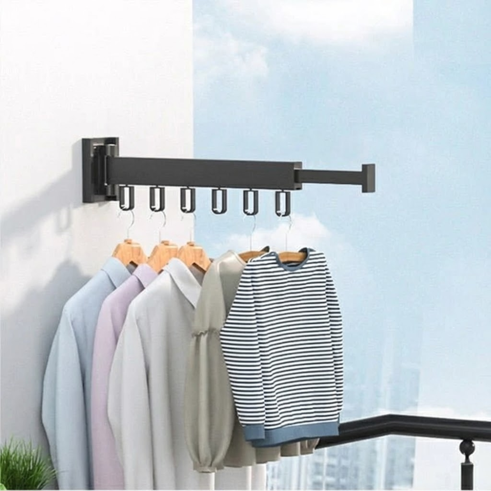 Clothing rack with clothes hanging on it against a light blue sky.
