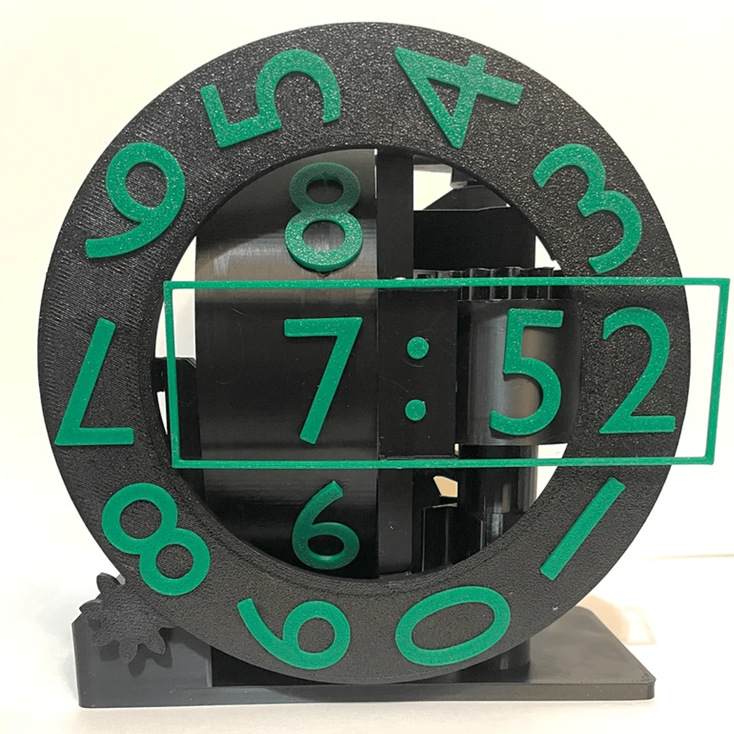 Black and green clock with flip-out numbers on a white background