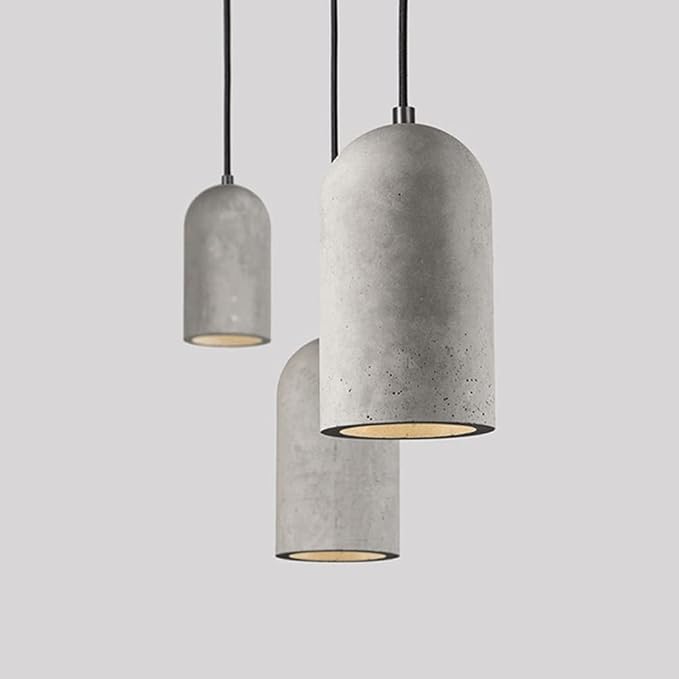 Three concrete pendant lights on a gray background