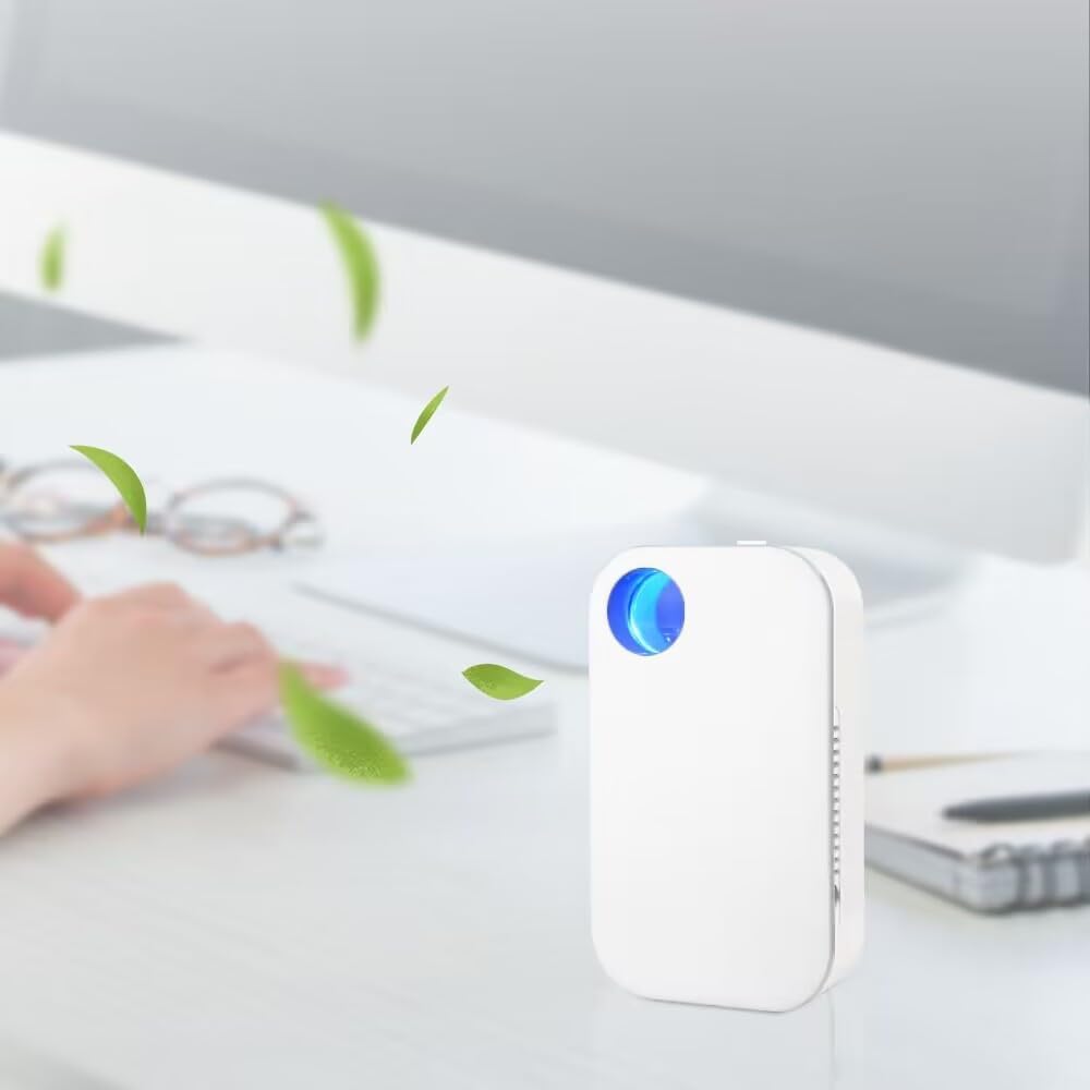 Small white device with a blue light on a desk, likely an air purifier, with a blurred office background.
