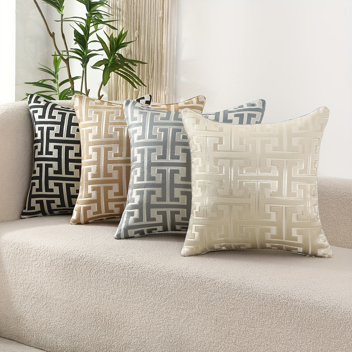 Decorative pillows with geometric patterns on a beige sofa.