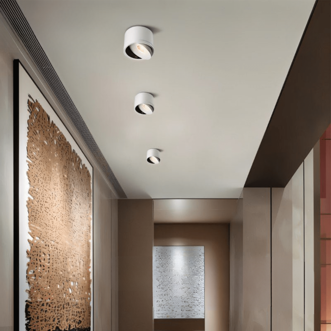 Modern hallway with recessed ceiling lights and textured wall art.