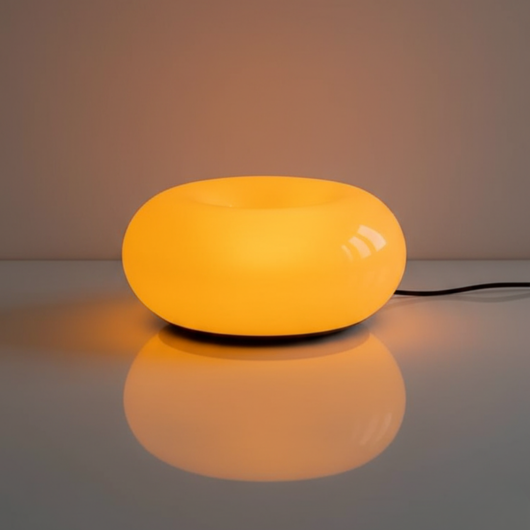 Yellow lamp on a reflective surface with a neutral background