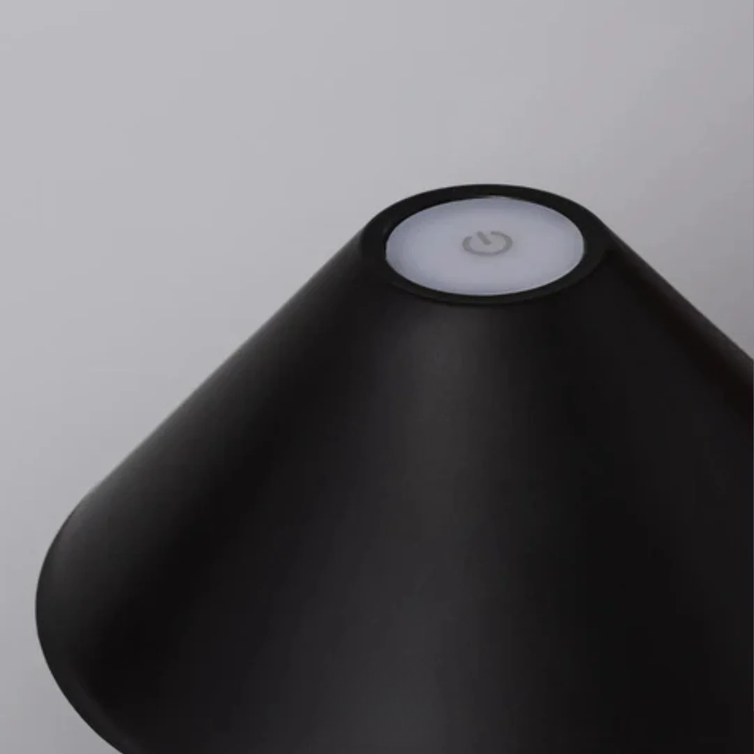 Black lampshade with a light switch on a gray background