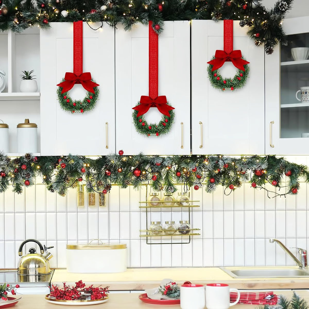Decorative Christmas wreaths and garlands on a kitchen cabinet with festive decor.