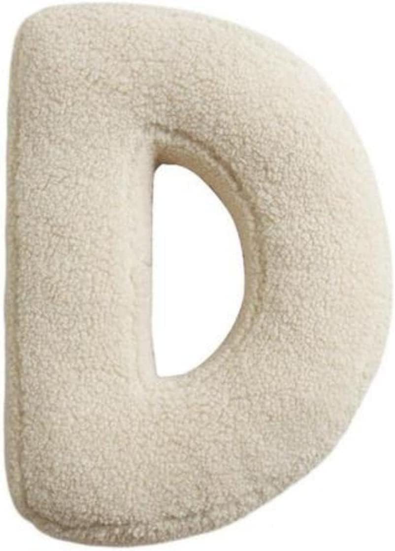 Beige letter 'D' made of soft material on a white background