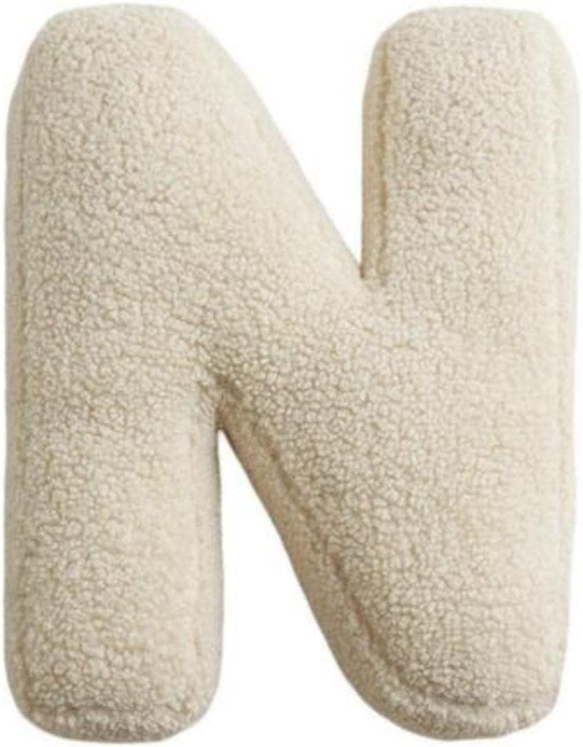 Beige letter 'N' made of textured fabric on a white background