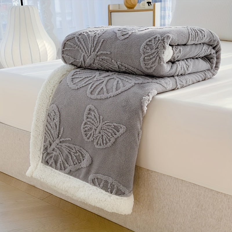 Gray butterfly-patterned blanket on a bed