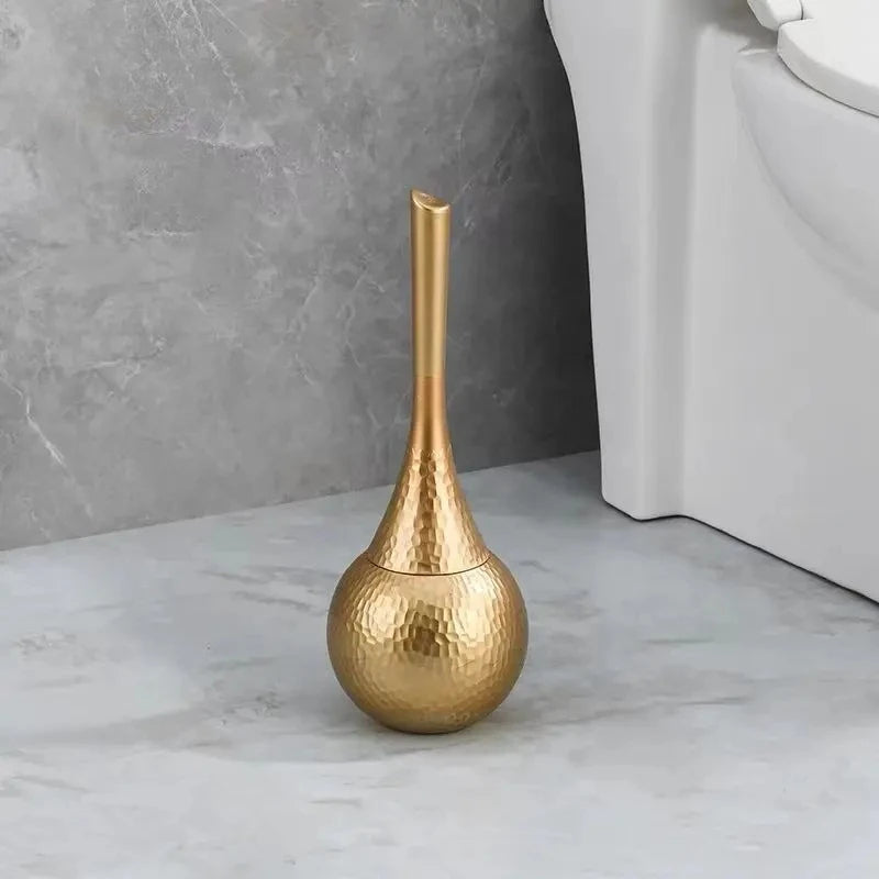 Gold decorative vase on a marble floor with a neutral wall background