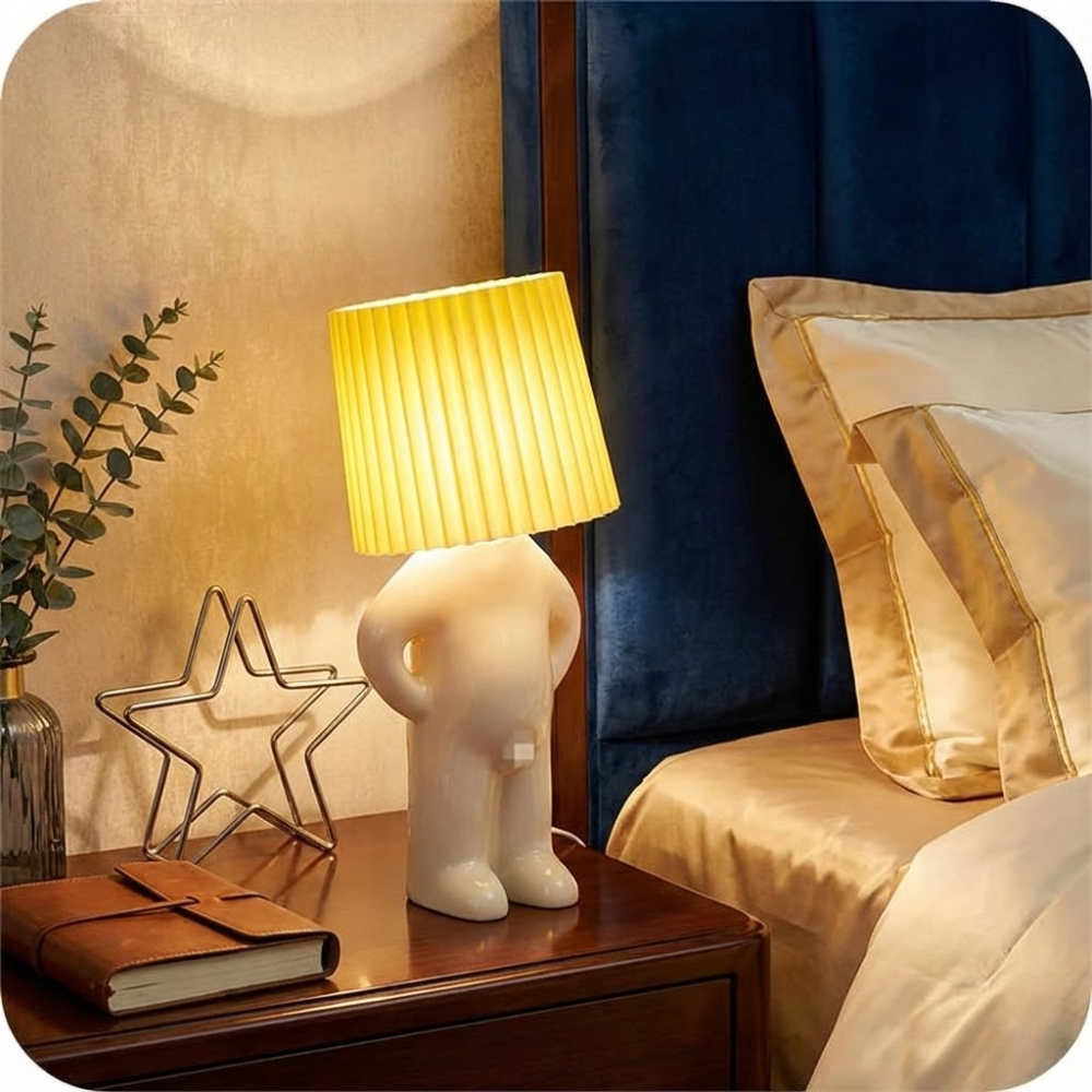 Decorative lamp on a bedside table next to a bed with pillows