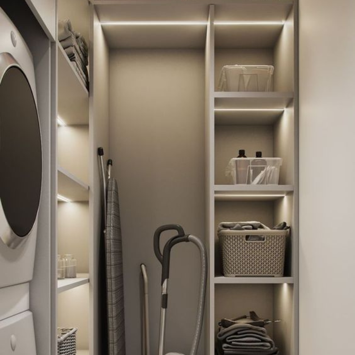 Modern laundry room with shelves, baskets, and cleaning supplies.