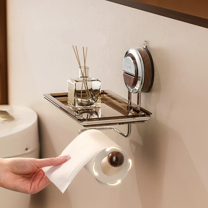 Bathroom shelf with a roll of toilet paper, diffuser, and mirror on a beige wall.