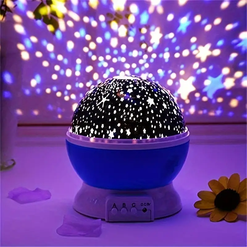 Starry night light projector with colorful starry sky projection on a purple background