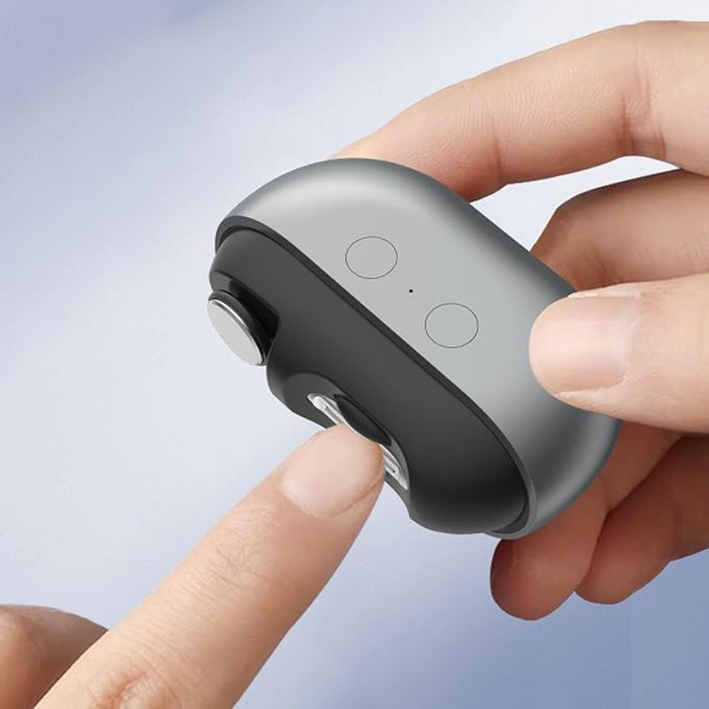 Hand holding a small electronic device with buttons on a light gray background