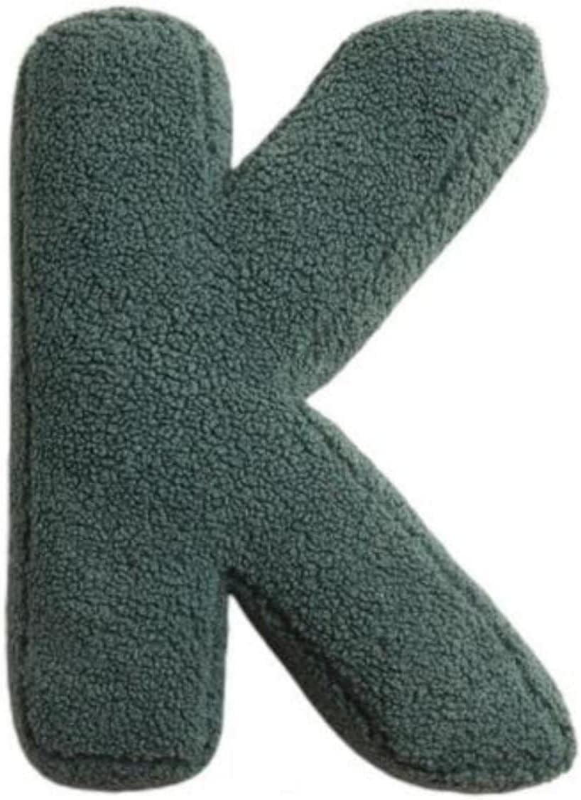Green letter 'K' shaped object on a white background