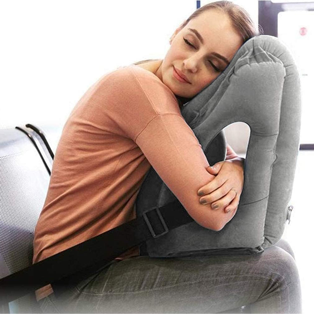Person using a travel pillow in an airplane seat