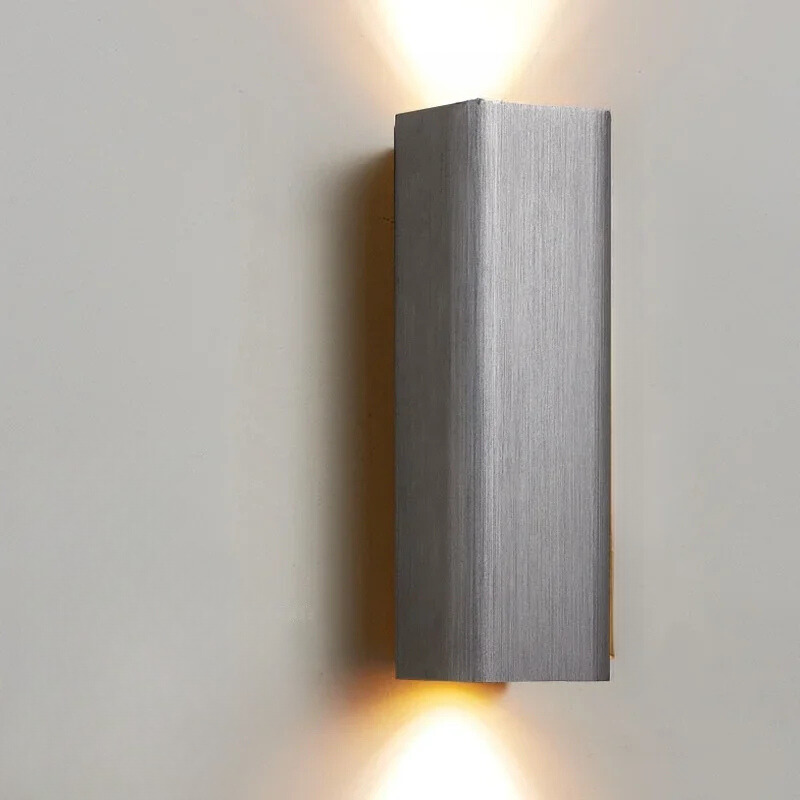 Modern wall-mounted light fixture on a plain wall