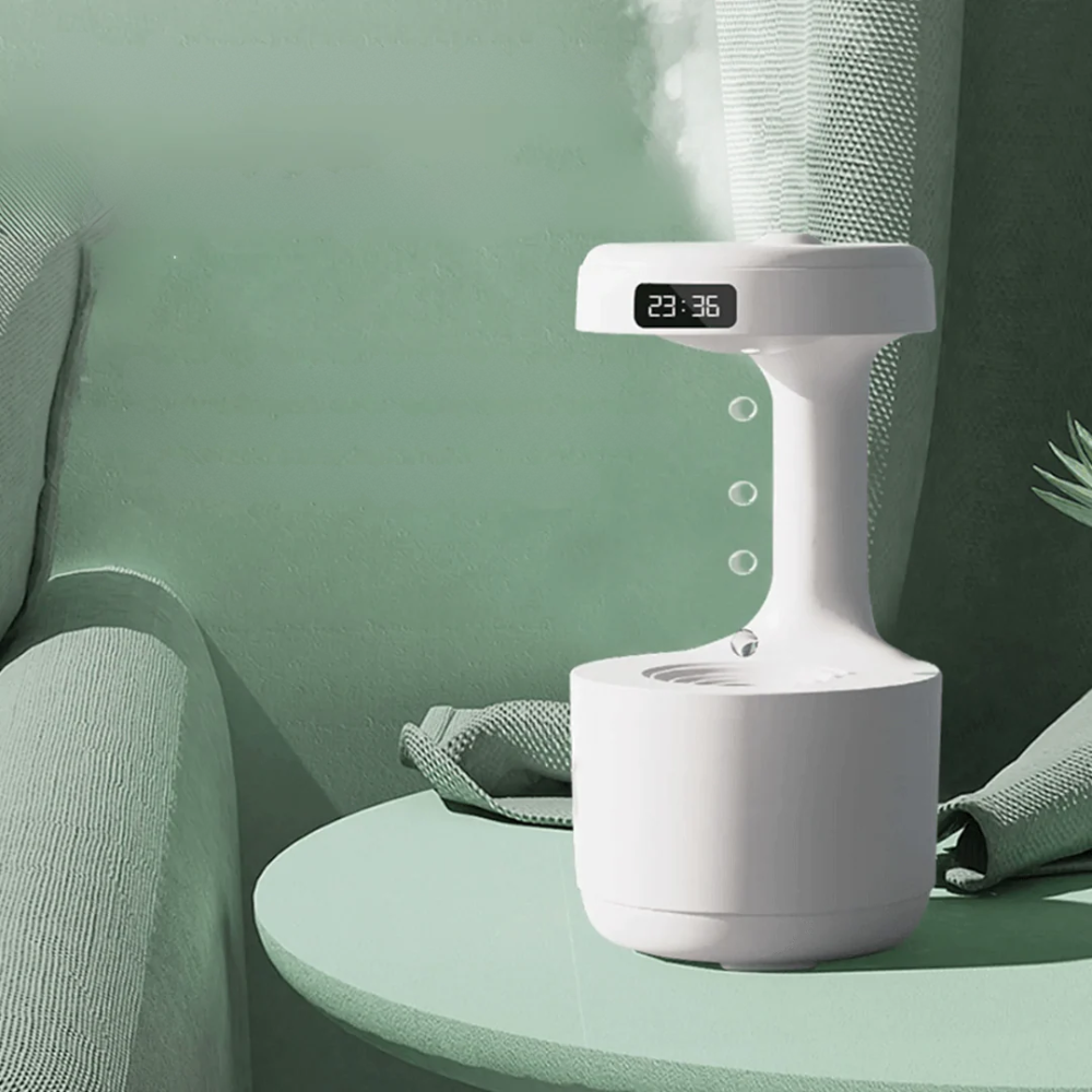 White humidifier with digital display on a green surface
