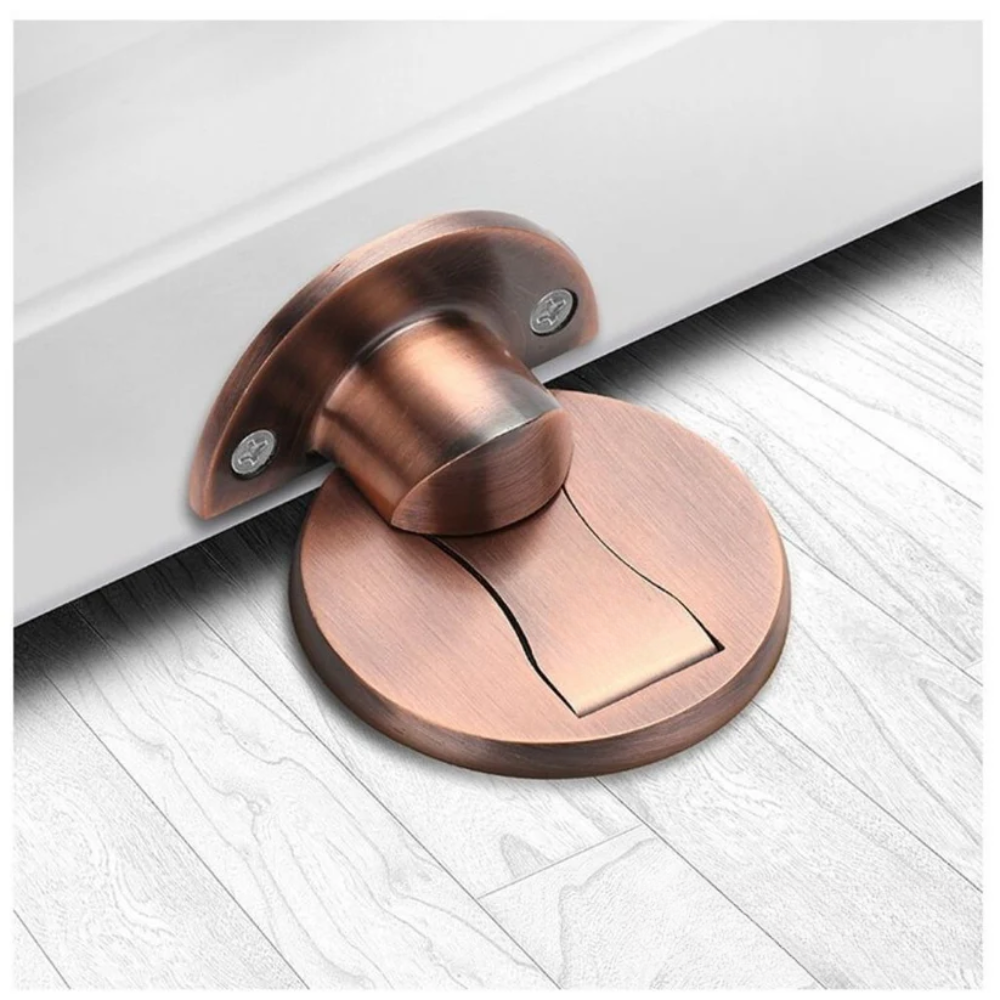 Copper door stopper on a white floor