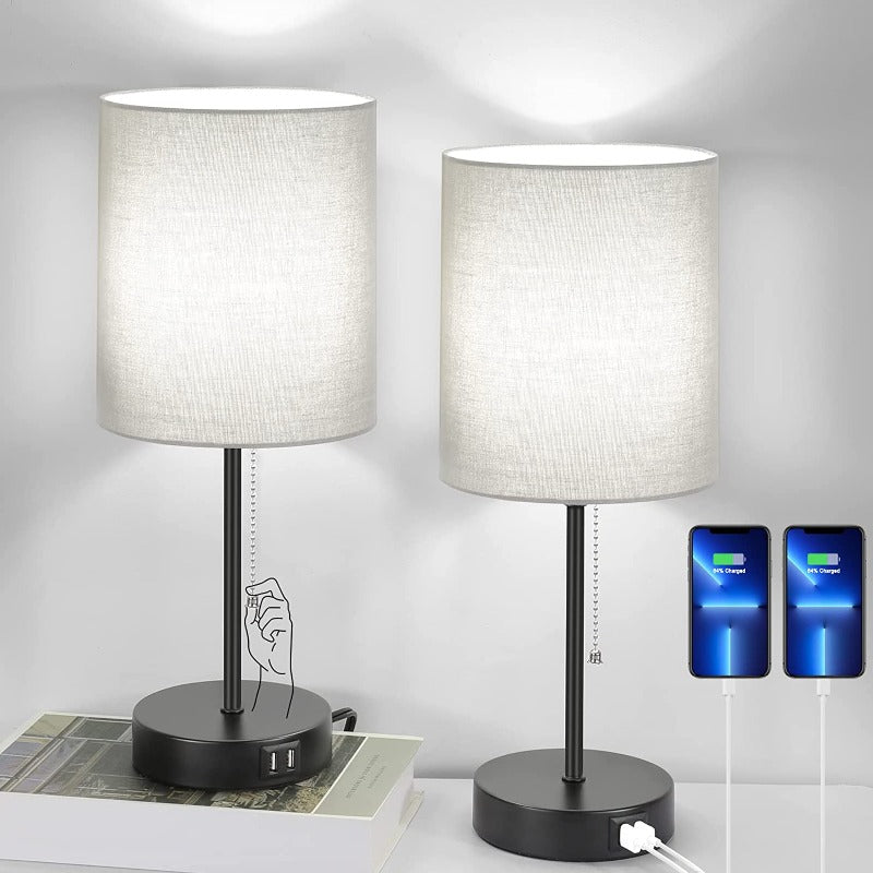 Two table lamps with USB charging ports on a white surface.