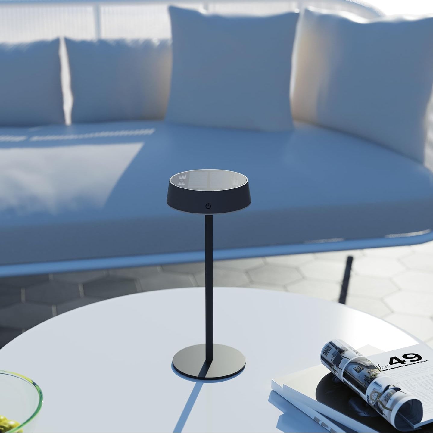Modern outdoor table lamp on a round white table with a blue sofa in the background