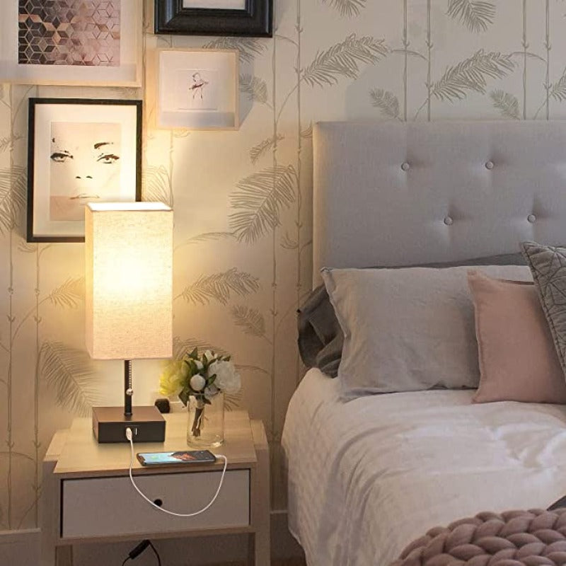 Neatly arranged bedroom with a bed, nightstand, and wall art.