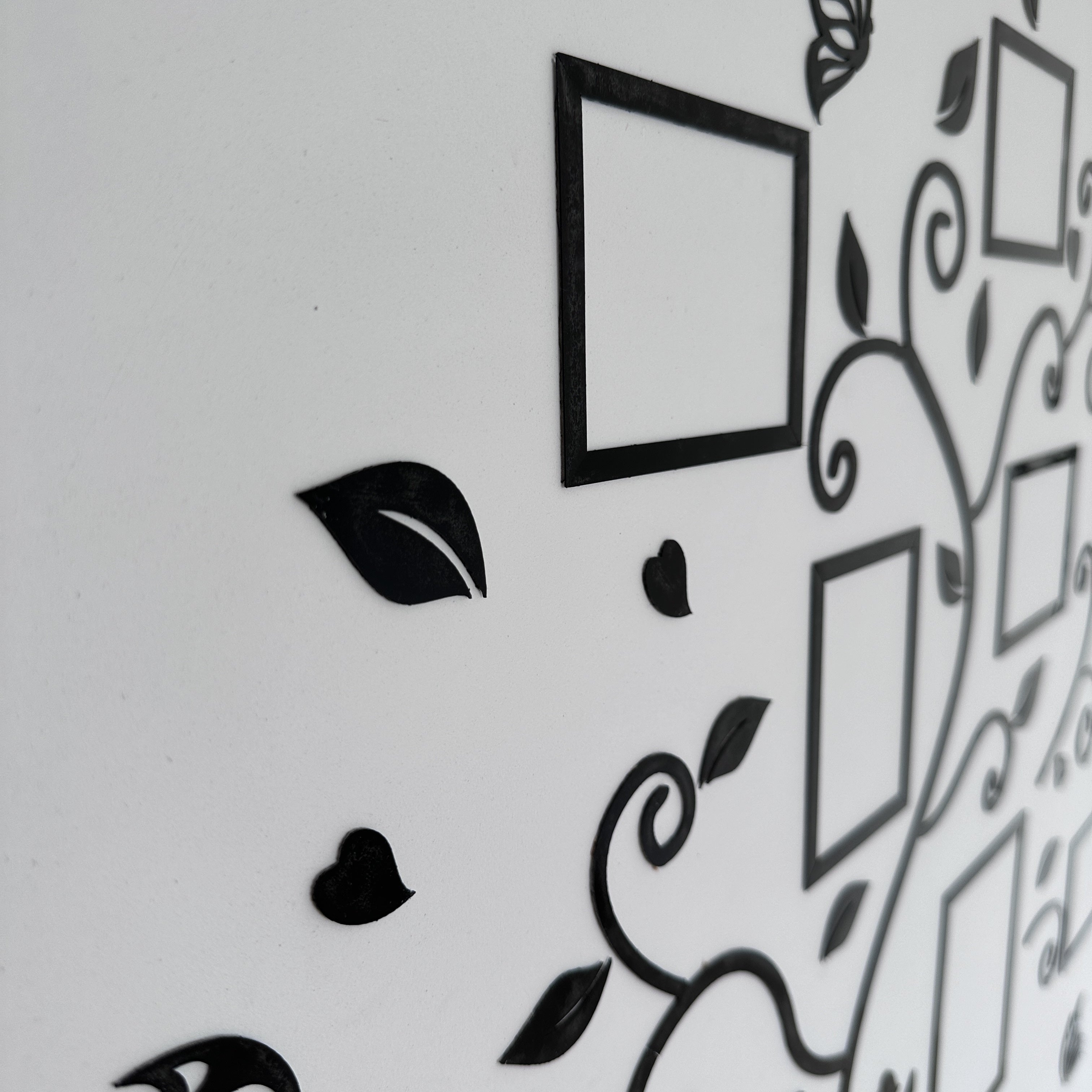 Decorative wall stickers with black frames and leaves on a white background