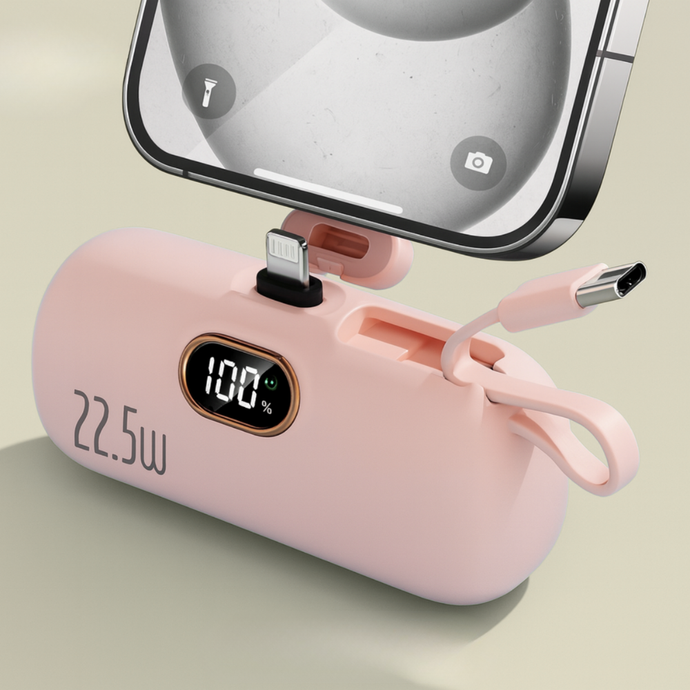 Pink power bank with digital display and phone clip on a light green background