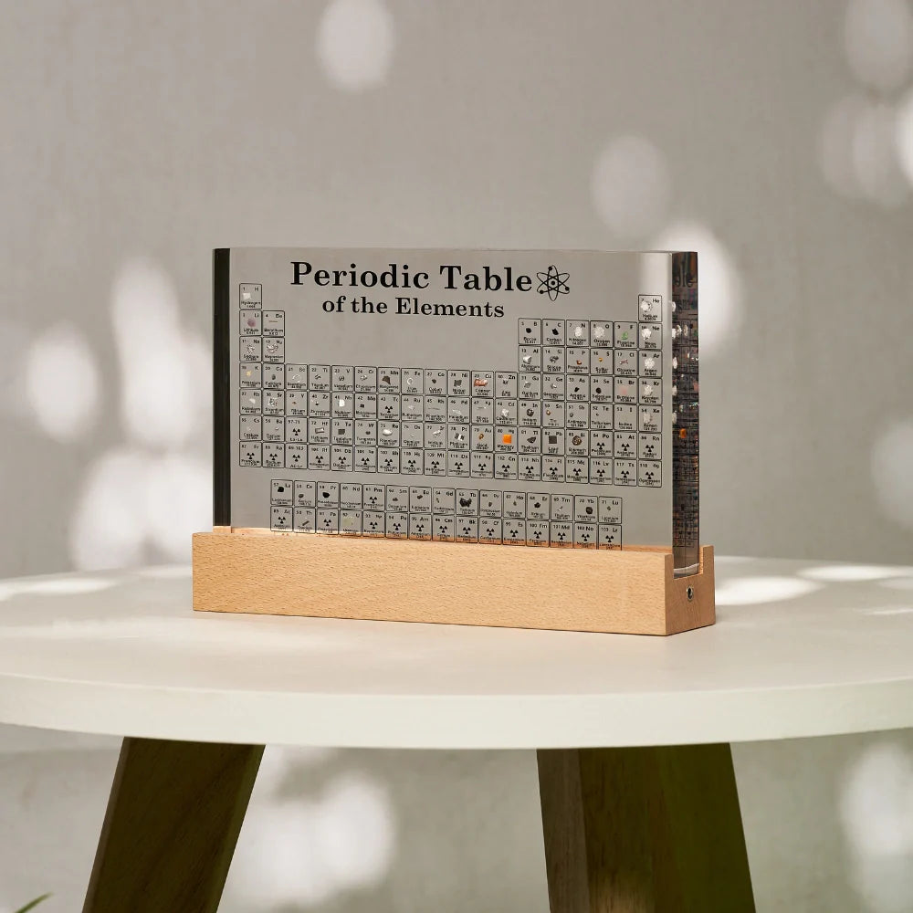 Periodic Table of Elements on a wooden stand with a blurred background