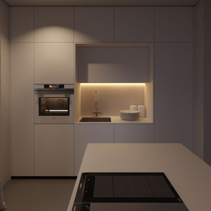 Modern kitchen with white cabinets, black appliances, and a light under-cabinet lighting.