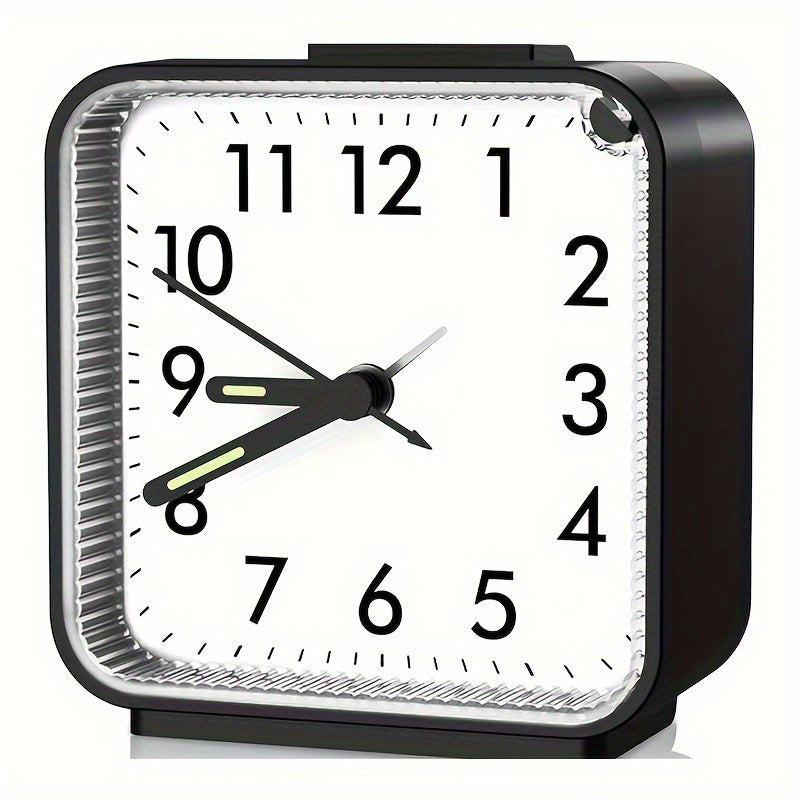 Black alarm clock with a white face on a white background