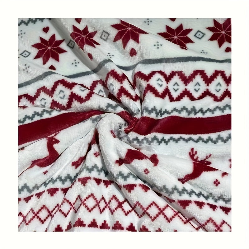 Close-up of fabric with red, gray, and white pattern featuring reindeer and geometric shapes.