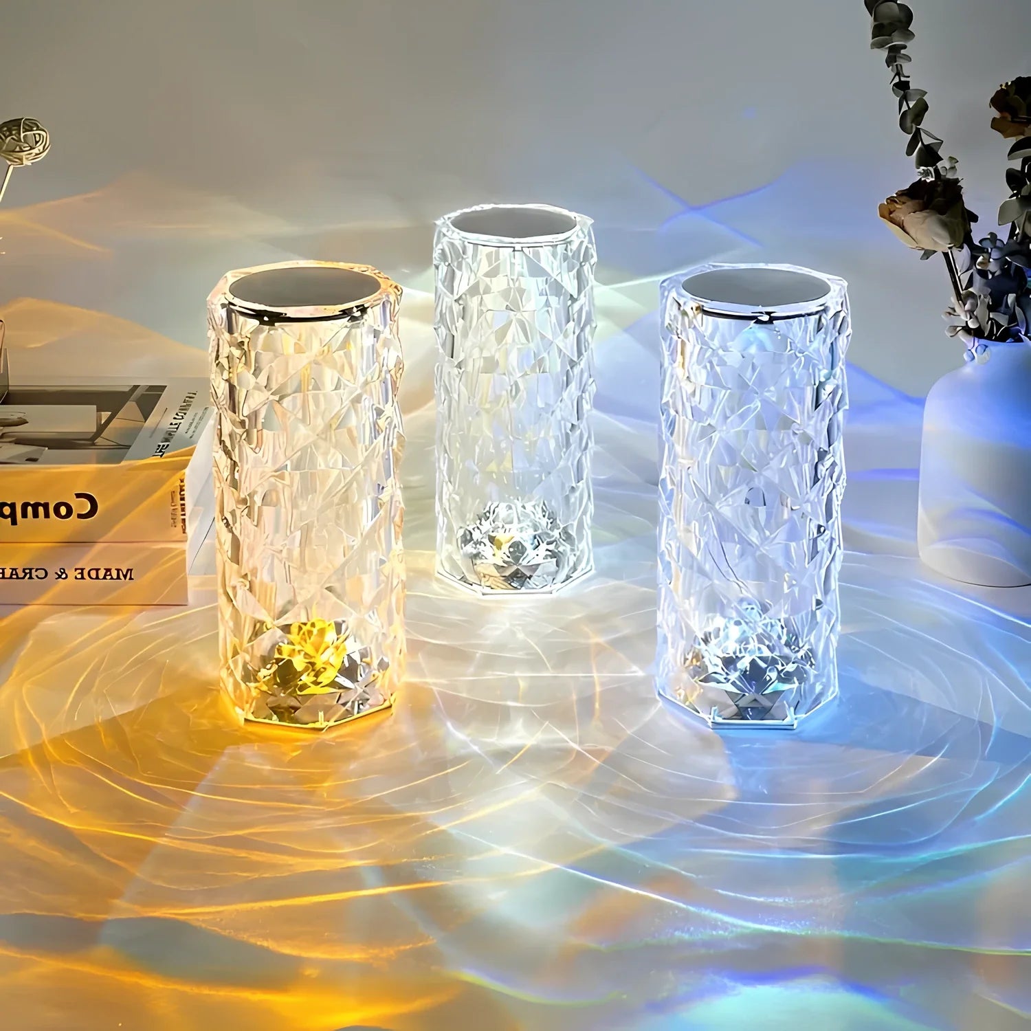 Three glass candle holders with textured surfaces on a reflective surface.