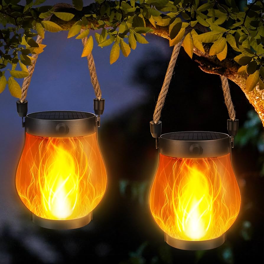 Two hanging solar lanterns with flame-like design against a dark background.
