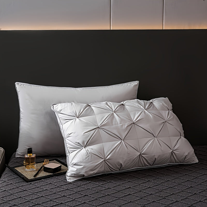 Two white pillows on a textured surface with a dark headboard in the background.