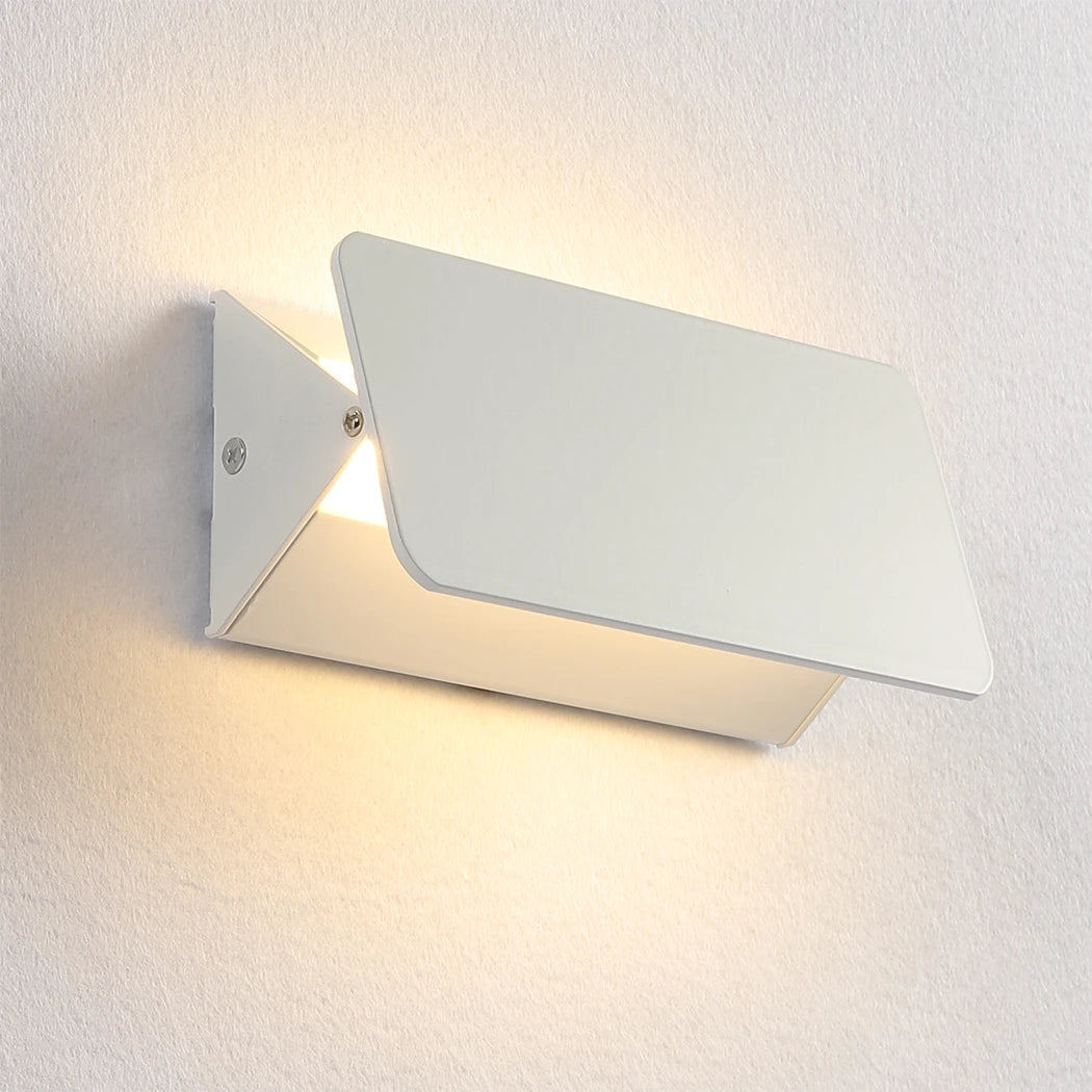 Modern white wall light fixture on a textured white wall