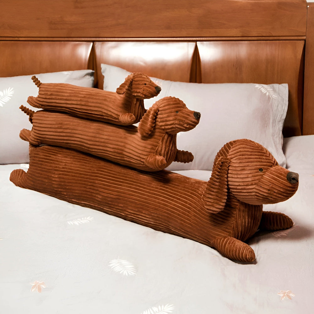 Three brown dog-shaped pillows stacked on a bed with a wooden headboard.
