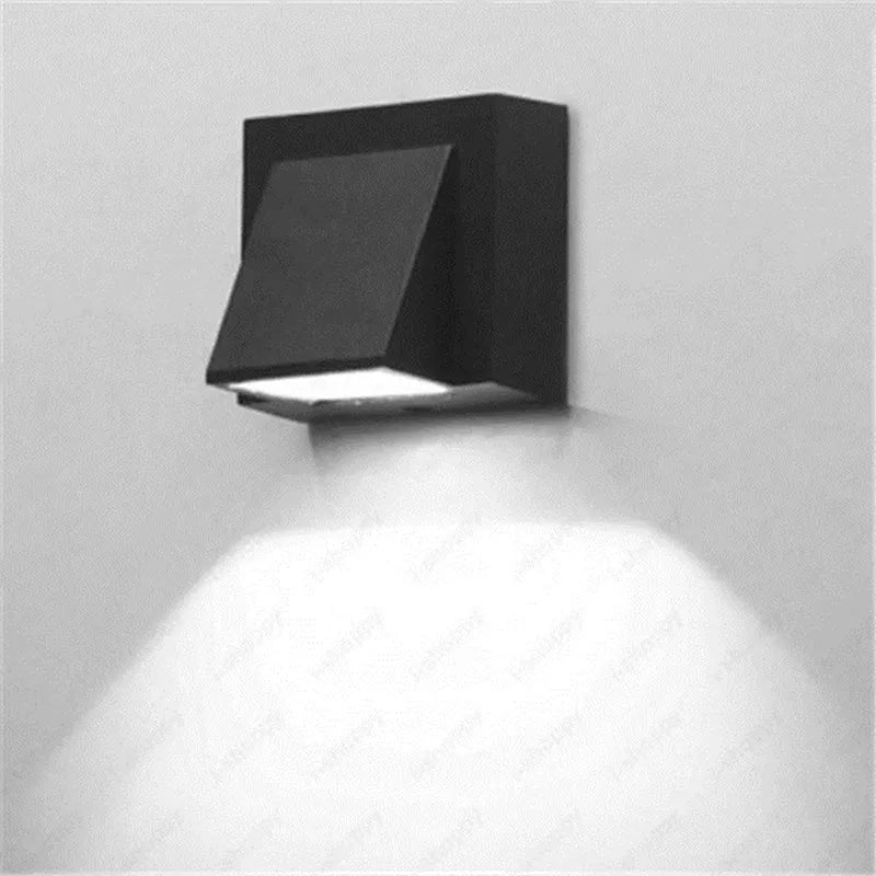 Black outdoor wall light fixture on a gray wall