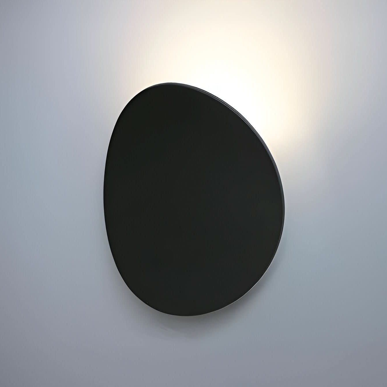 Black wall-mounted light fixture on a gray background