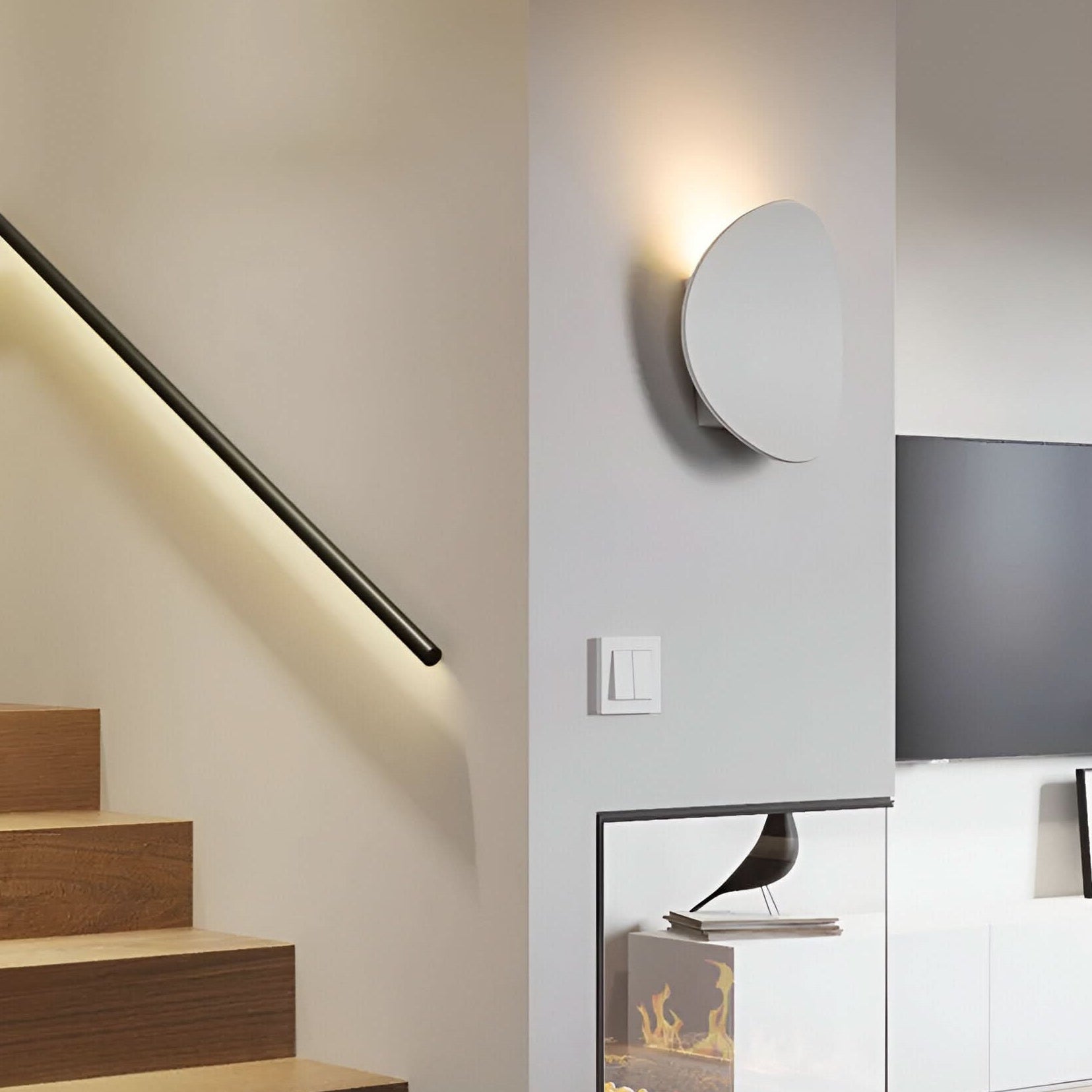 Modern interior with staircase, wall-mounted light fixture, and built-in fireplace.