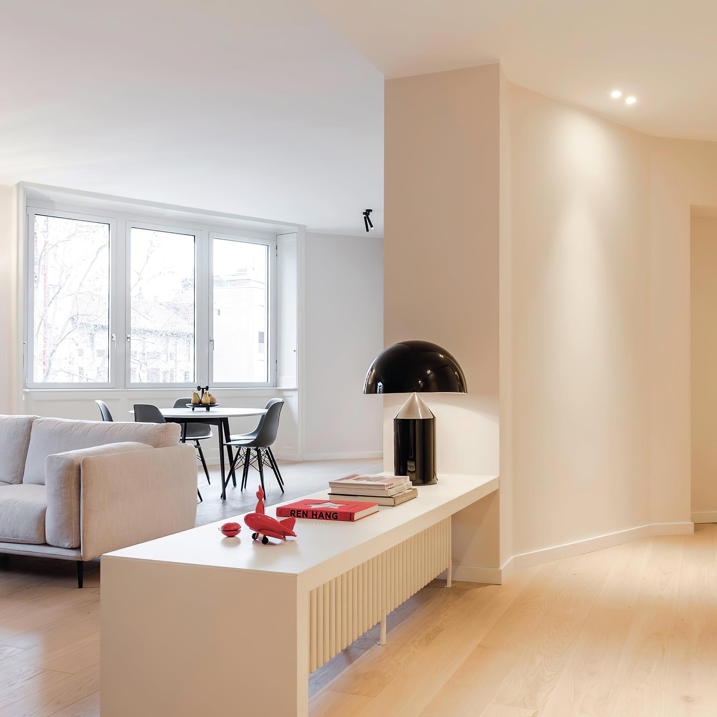 Modern living room with a white sofa, coffee table, and decorative items.