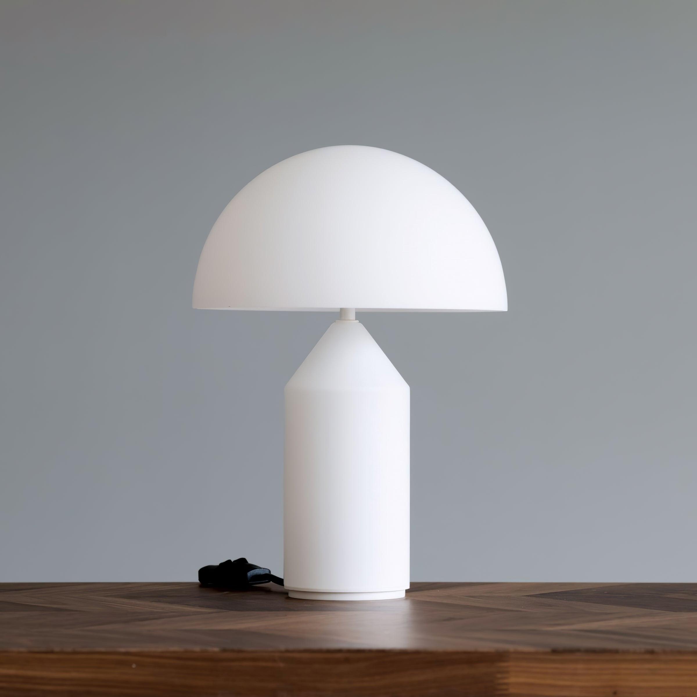 White table lamp on a wooden surface with a gray background