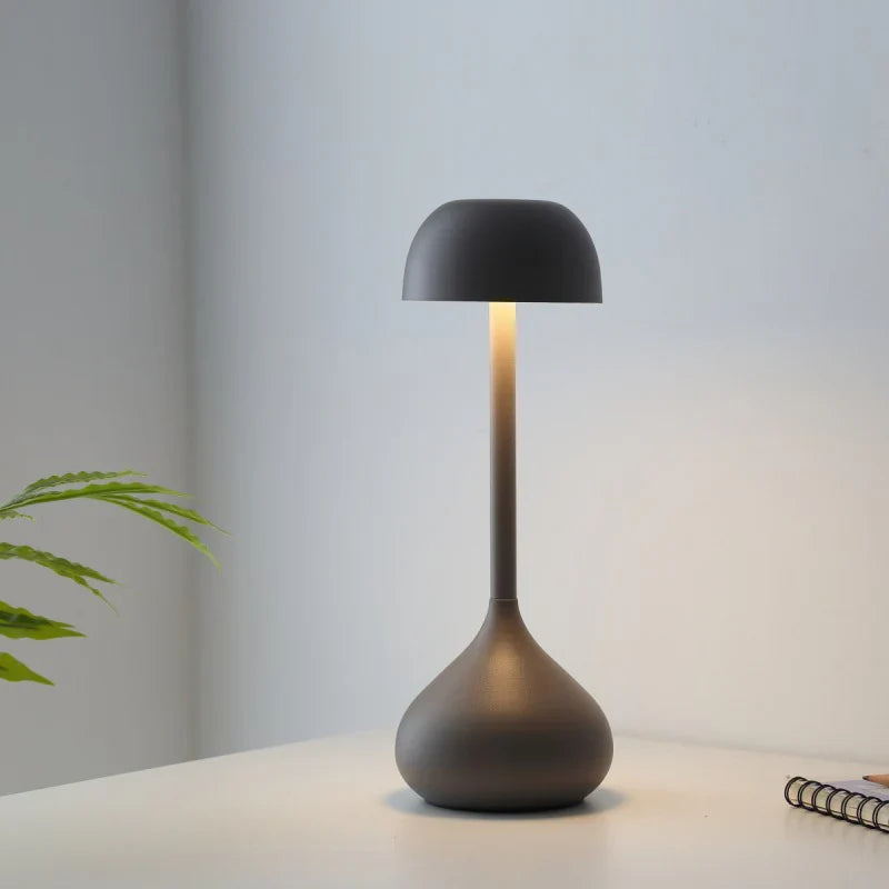 Modern black table lamp on a light surface with a neutral background
