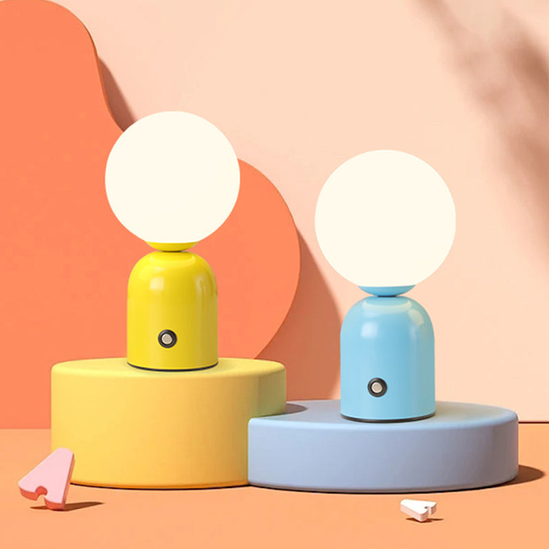Two colorful table lamps, one yellow and one blue, on a geometric background.