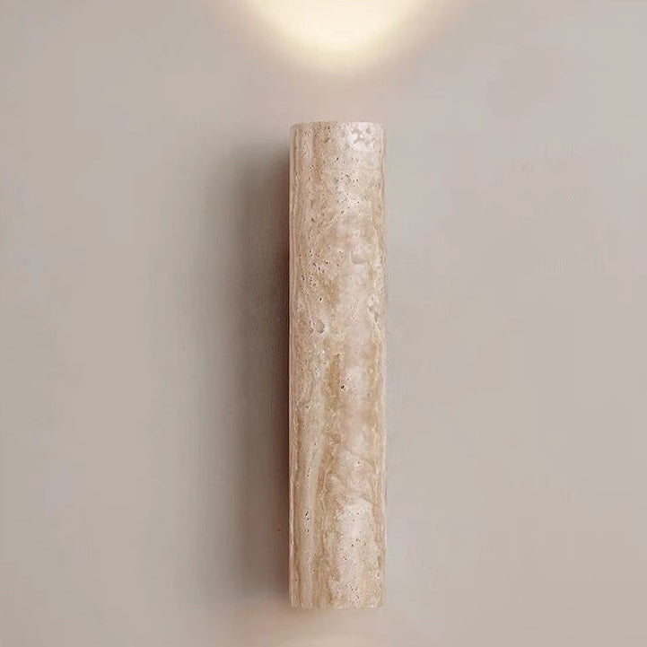 Cylindrical wall sconce on a plain wall