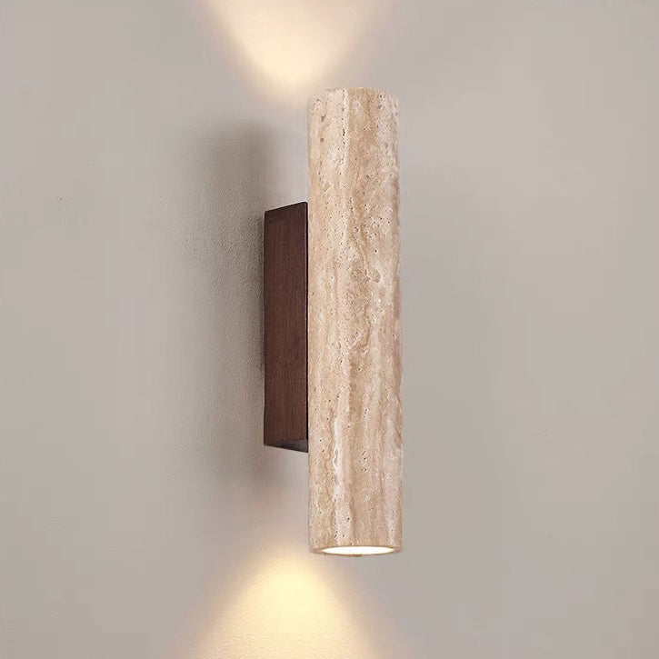 Cylindrical wall light fixture with textured beige cover and dark wooden base on a neutral background
