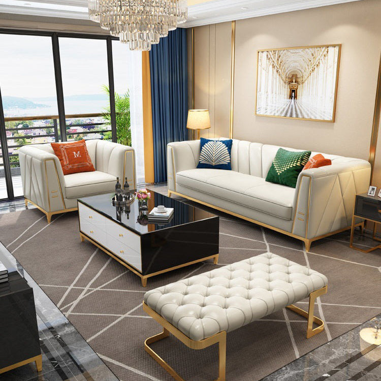 Modern living room with white sofa, coffee table, and decorative pillows.